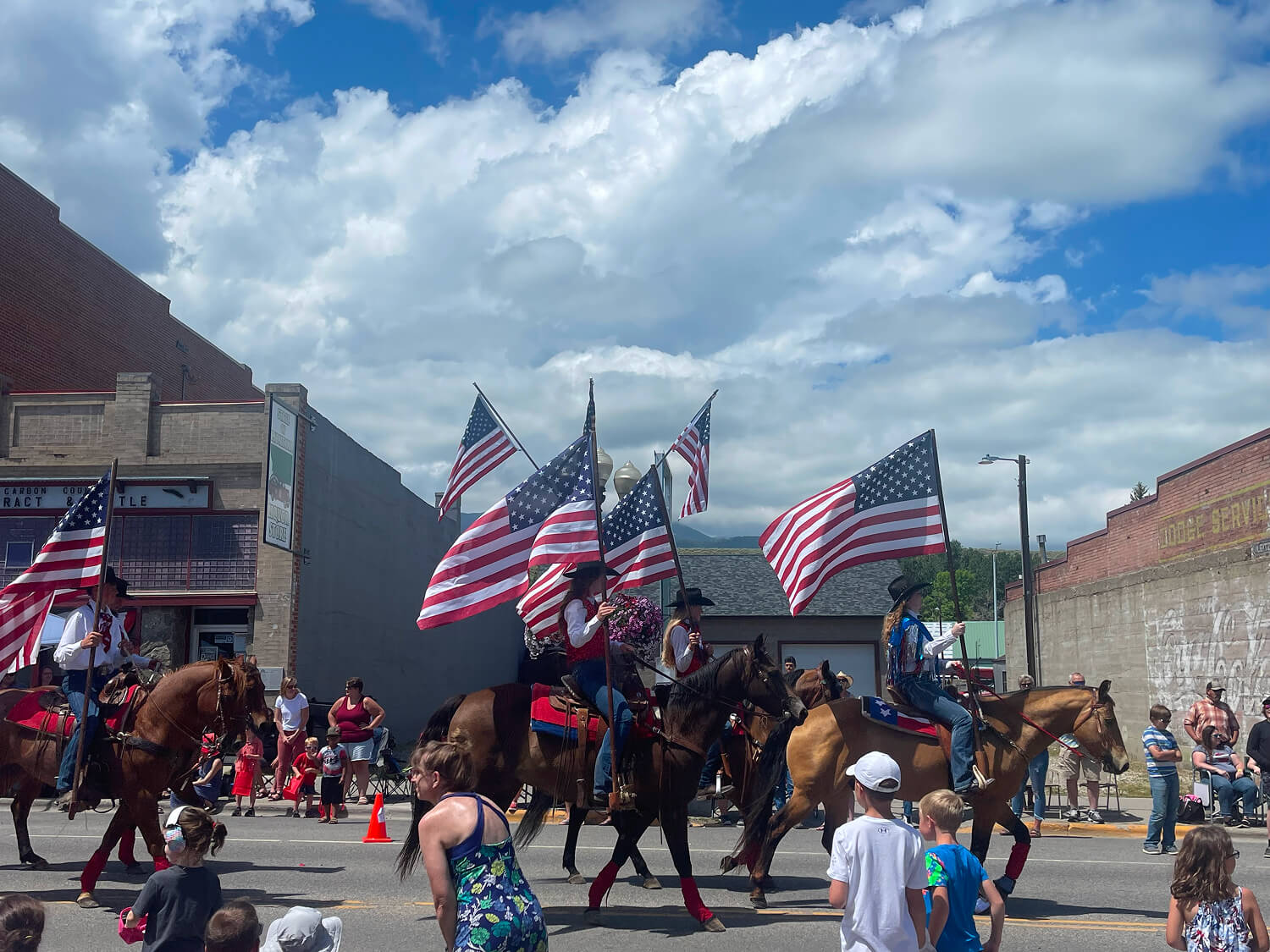 Parade with horses and American flags.