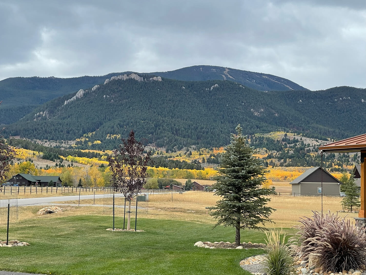 Mountain landscape with autumn trees and houses.